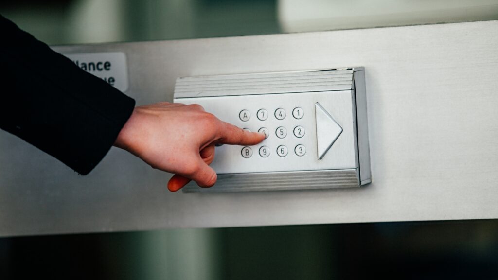 Entering a passcode on an electronic key entry pad for access.